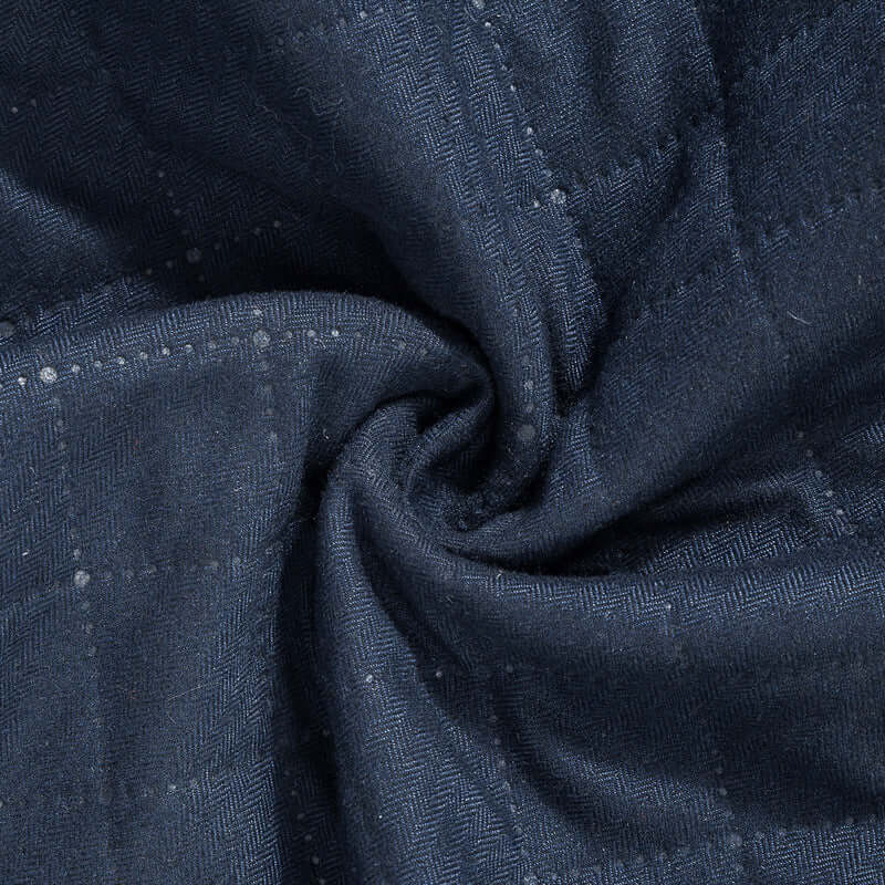 Close-up of textured navy fabric, showcasing a herringbone pattern perfect for autumn apparel.