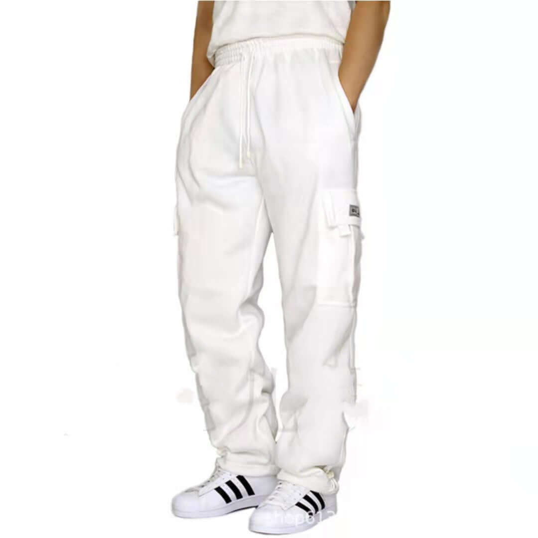 Men's white jogger sweatpants with drawstring and pockets, styled with sporty sneakers.