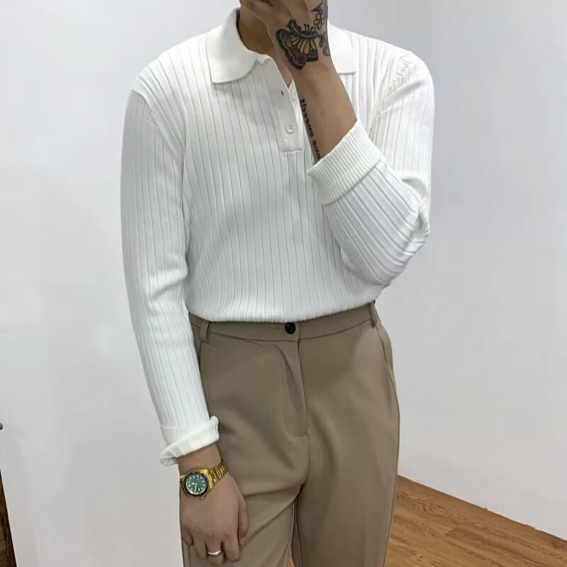 Men's slim knit polo shirt in white with textured waffle design, styled with beige trousers.