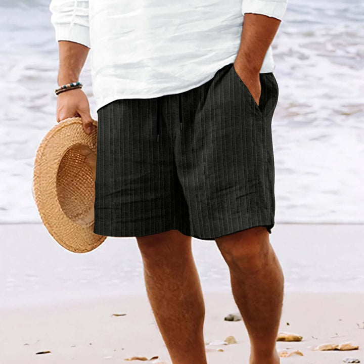 Summer fashion drawstring shorts with pockets, perfect for beach days or casual outings, shown on sandy beach.