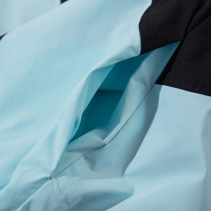 Close-up of fabric texture and ventilation design of a sun-protective wind coat for men in blue and black.
