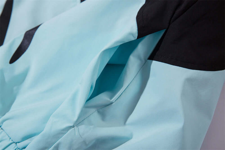 Close-up of a lightweight sun-protective wind coat for men in light blue with adjustable features.