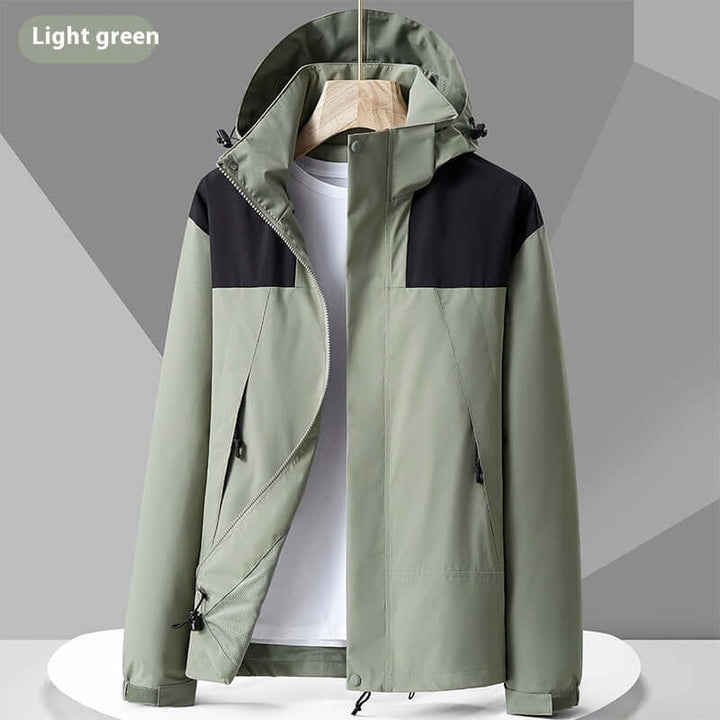 Light green waterproof colorblock windbreaker jacket with hood, suitable for outdoor adventures and urban wear.