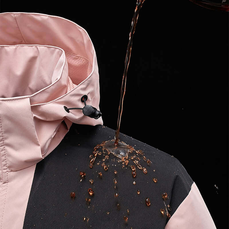 Waterproof colorblock windbreaker jacket with water beading off the fabric, showcasing its durability and style.