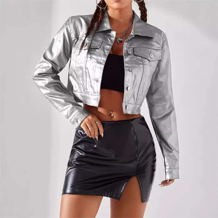 Women's street style coated jacket in silver with cropped design, paired with a black skirt for a bold urban look.
